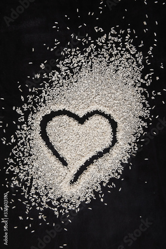 heart made of rice on dark background