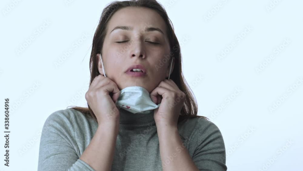 Choking girl in medical mask nervously tears it off, takes breaths of fresh air Choking girl in medical mask nervously tears it off, takes breaths of fresh air