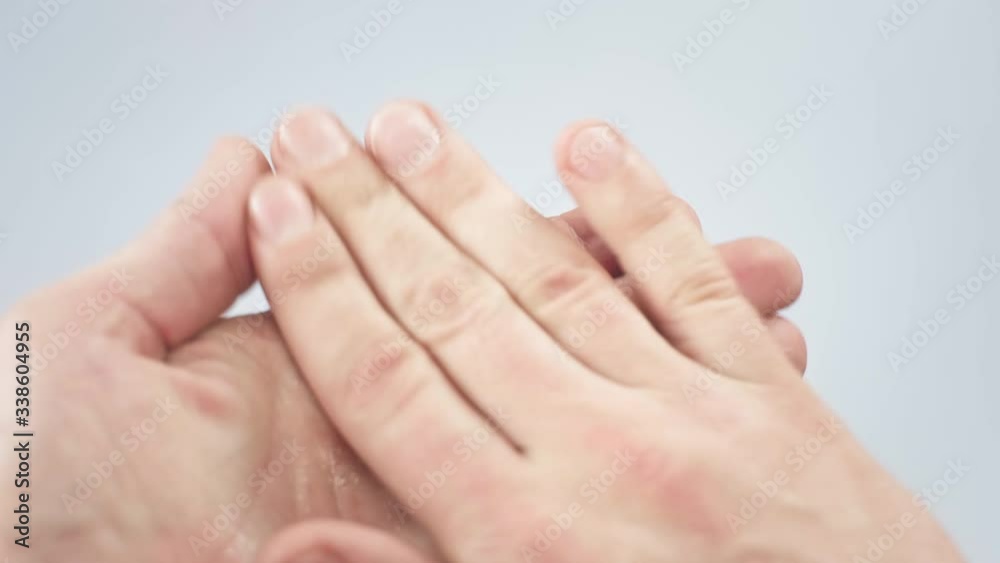 Cleaning hands with waterless, alcohol-based hand sanitizer antiseptic gel. Man holds a bottle for handrubs and pours liquid, alternative to soap washing, used as hand disinfectant to kill bacteria. Cleaning hands with waterless, alcohol-based hand sanitizer antiseptic gel. Man holds a bottle for handrubs and pours liquid, alternative to soap washing, used as hand disinfectant to kill bacteria.