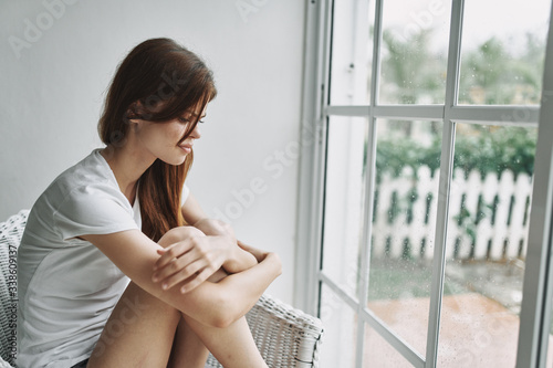 young woman looking out window Free Download young woman looking out window - GFXLoad