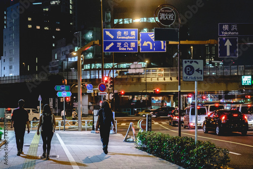 Photography Young backpackers walking on the streets of Tokyo downtown, Japan