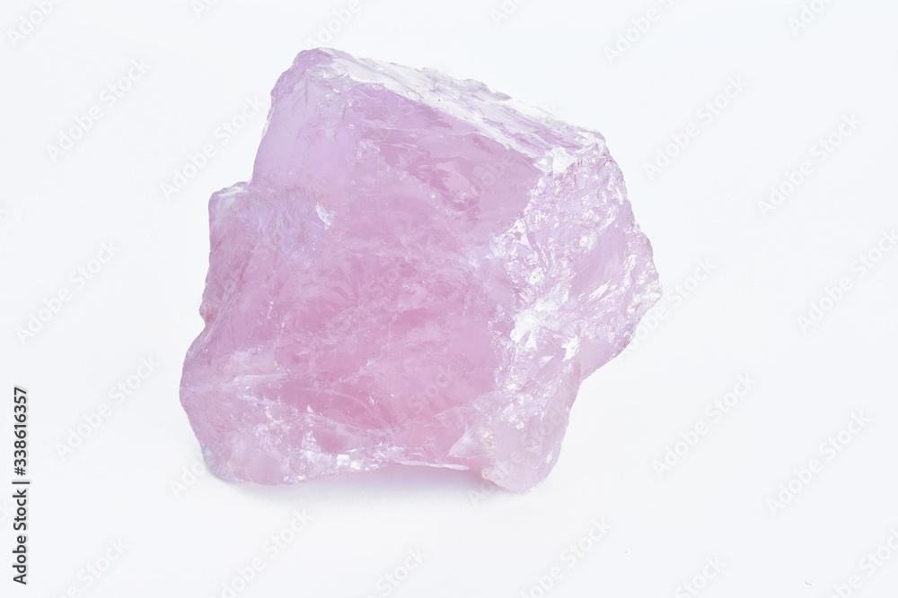 A close up image of a raw rose quartz crystal. 