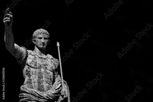 Caesar Augustus, first emperor of Ancient Rome and father of the nation. Old bronze statue along the Imperial Forum Road (Black and White with copy space) photo