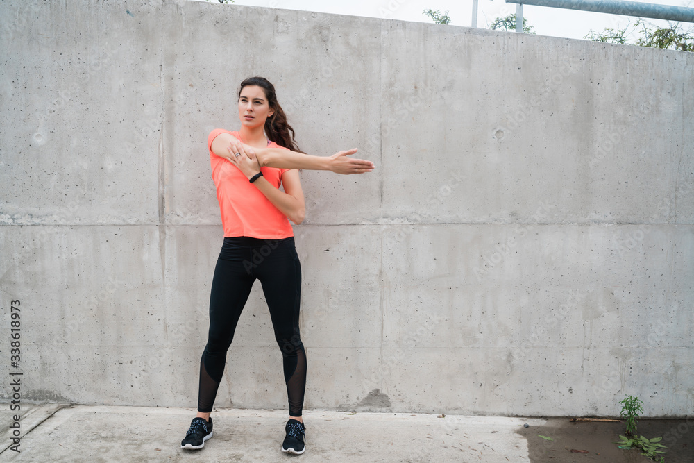 Athletic woman stretching legs before exercise. Athletic woman stretching legs before exercise.