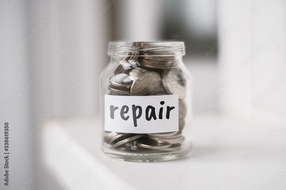 Concept of savings for repair - Glass jar with coins and the inscription. Concept of savings for repair - Glass jar with coins and the inscription.