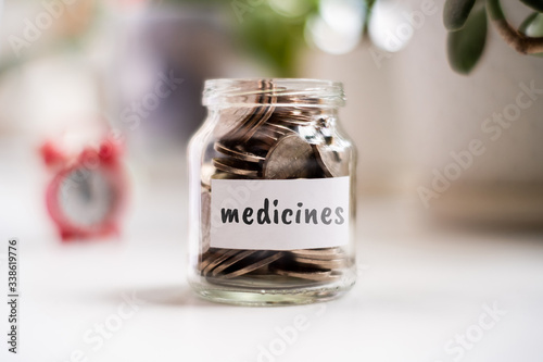Concept of savings on medicines - Glass jar with coins and an inscription.