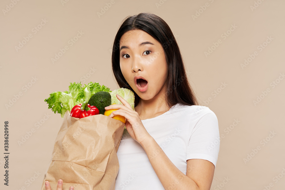 young woman holding a bowl of strawberries young woman holding a bowl of strawberries