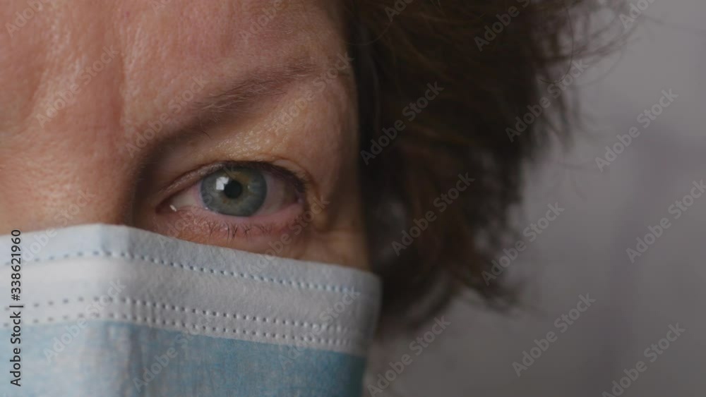 Close Up Portrait Of A Elderly Woman With Mask Looking To Camera. Female In The Medical Protection Mask. Coronavirus Or COVID19.. Close Up Portrait Of A Elderly Woman With Mask Looking To Camera. Female In The Medical Protection Mask. Coronavirus Or COVID19..