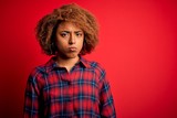 Young beautiful African American afro woman with curly hair wearing casual shirt depressed and worry for distress, crying angry and afraid. Sad expression.