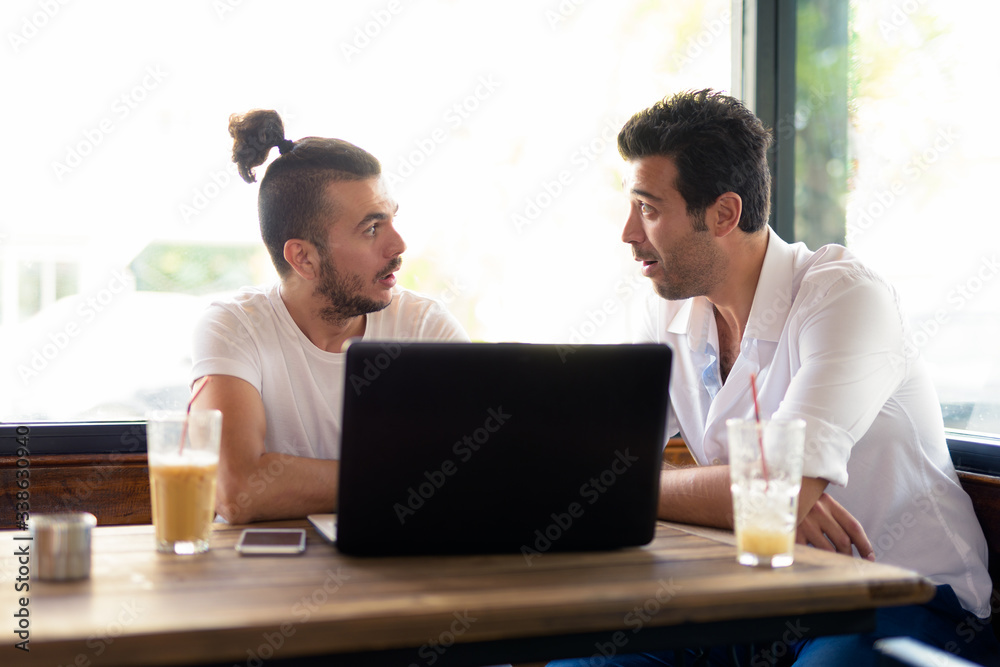 Two handsome Turkish men hanging out and relaxing at the coffee shop