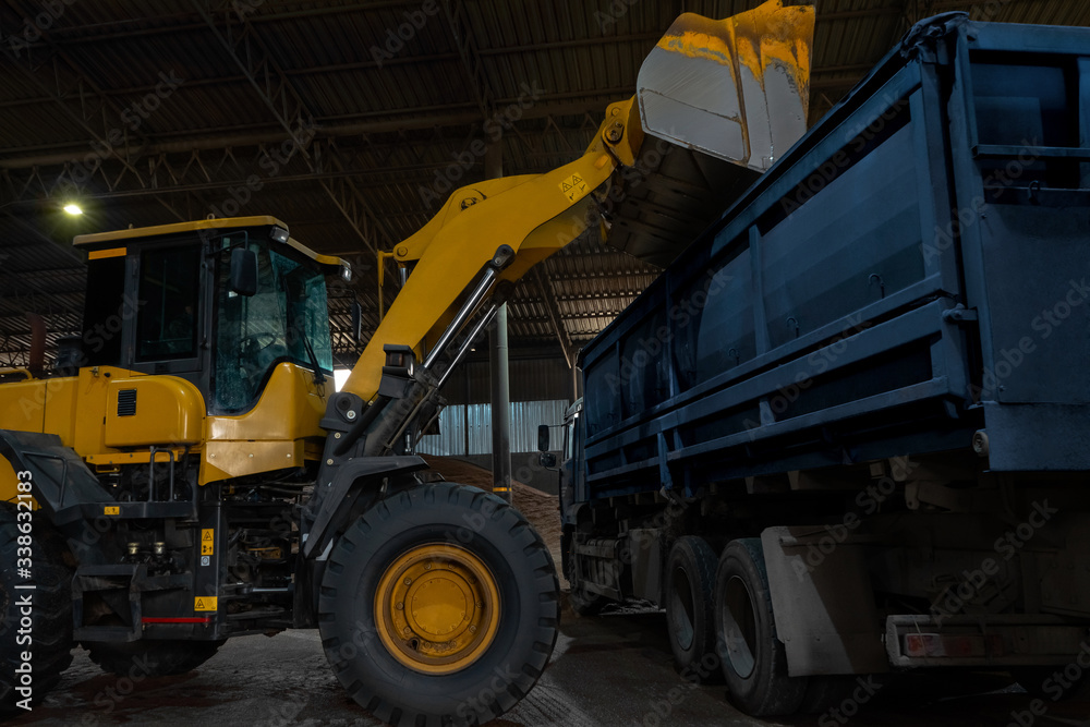 Loading a truck with cargo using a wheel loader, bucket.
