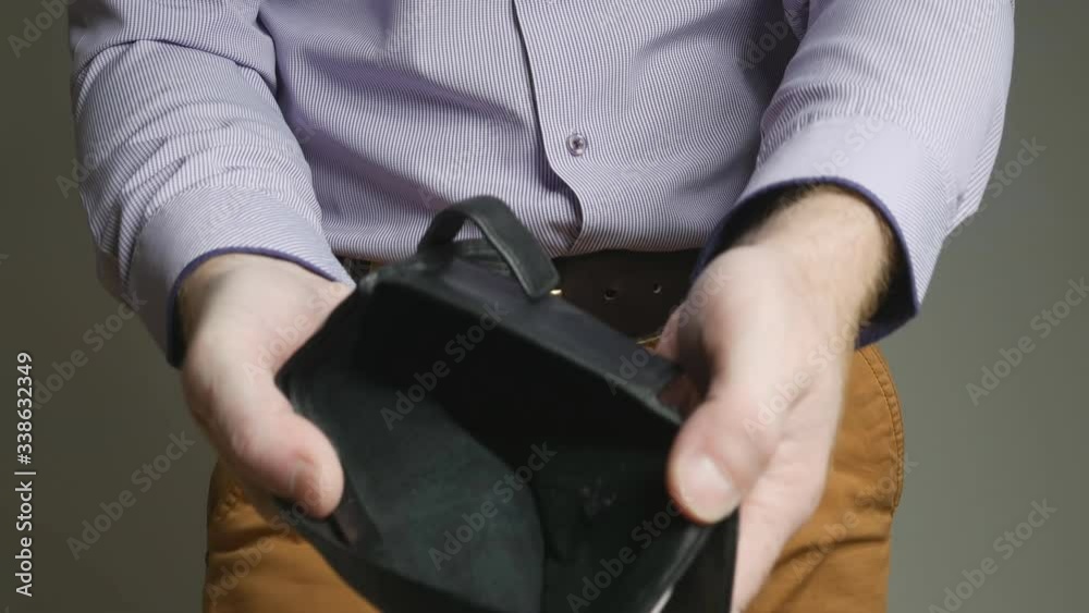 the businessman cheerfully shows off his empty wallet. He took it out of his pocket, opened it, and turned it over. Shook and threw on the floor. The concept of mental equilibrium