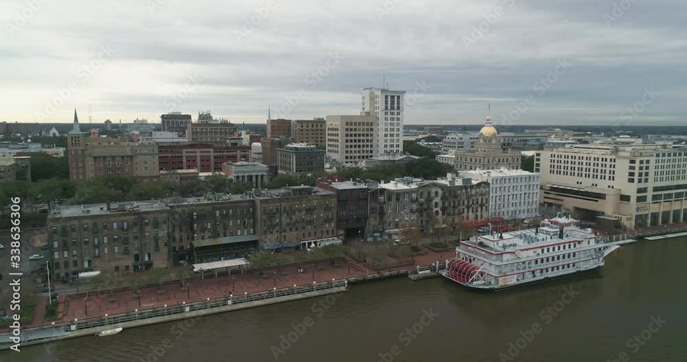 Aerial Shot of Savannah, Georgia Ascending Over the Savannah River With a Ferry Boat Near River Street on a Cloudy Day Aerial Shot of Savannah, Georgia Ascending Over the Savannah River With a Ferry Boat Near River Street on a Cloudy Day