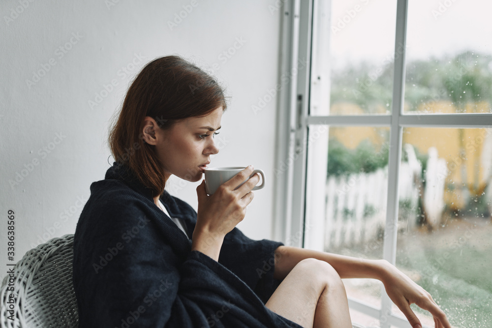 Fototapeta premium young woman sitting on a balcony