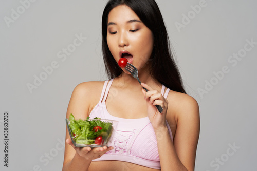 young woman eating a salad