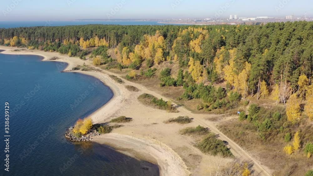 Autumn landscape with yellow forest on the shore of Ob sea and town Akademgorodok on background. Autumn landscape with yellow forest on the shore of Ob sea and town Akademgorodok on background.