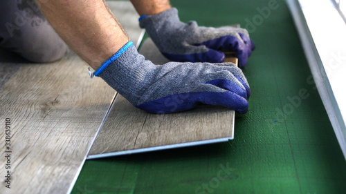 Man installing new laminated wooden floor.