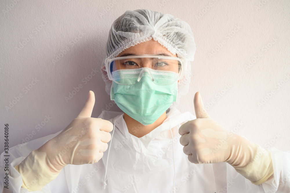 Nurse wearing PPE suit with mask for protect virus and showing thumbs up. In coronavirus pandemic outbreak we should support and encourage healthcare worker by stay home and listen to medical advice. Nurse wearing PPE suit with mask for protect virus and showing thumbs up. In coronavirus pandemic outbreak we should support and encourage healthcare worker by stay home and listen to medical advice.