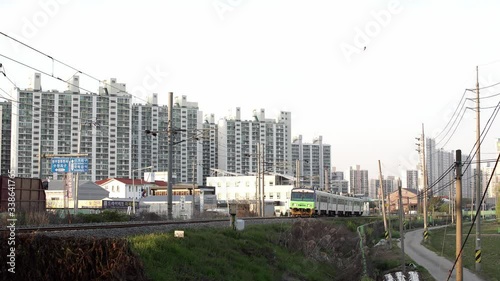 Korean train running on rail with apartment background