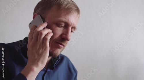 young man with a beard calls on a mobile phone