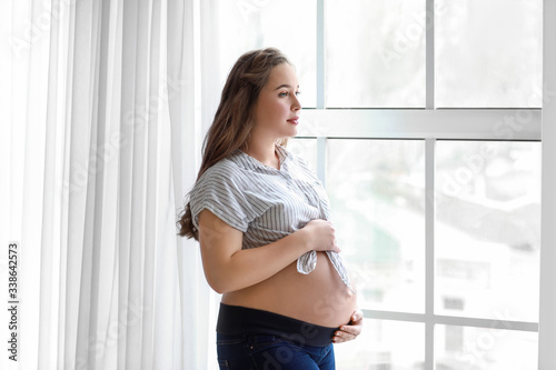 Free Download Beautiful pregnant woman near window - GFXLoad