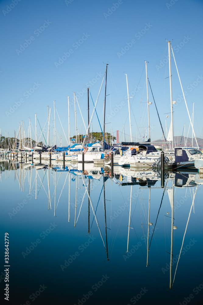 Reflections of boats docked in the bay in San Francisco. 