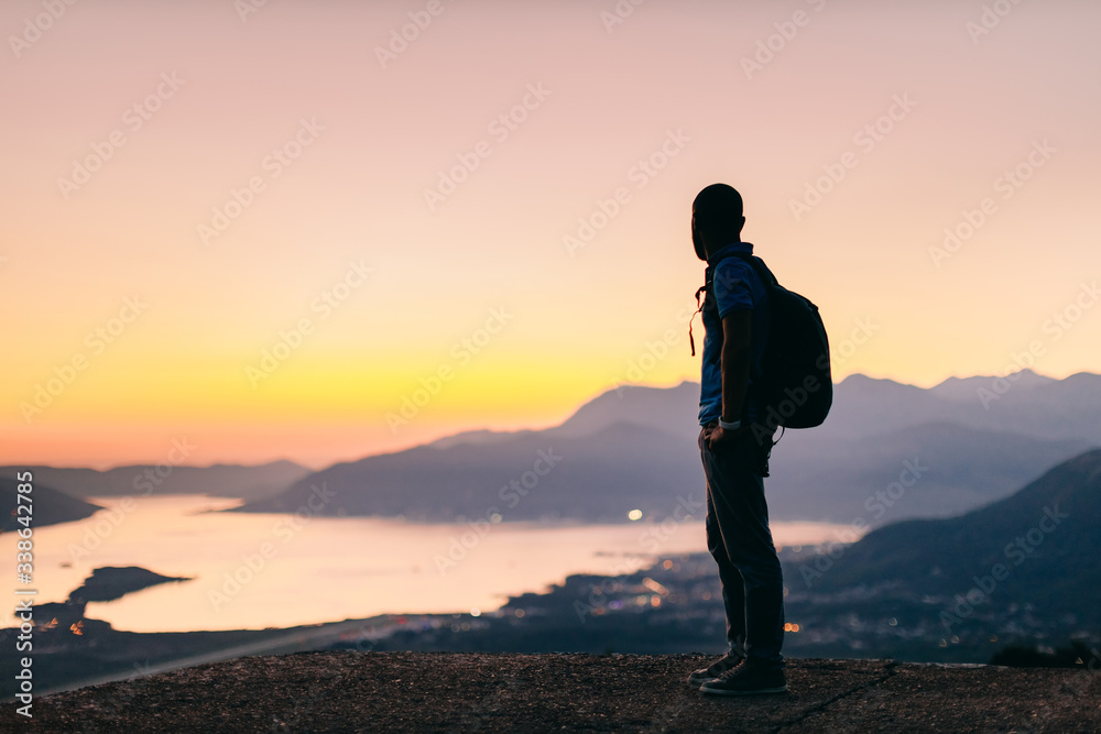 man travel mountains with sea view at sunset