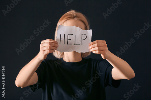 Woman holding paper sheet w...