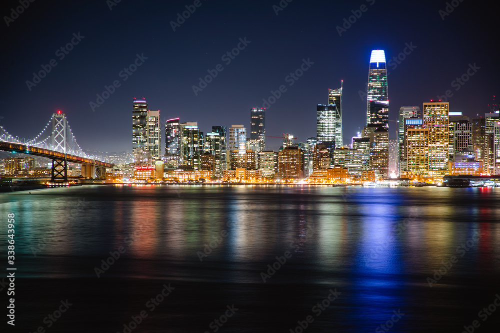 Nighttime view of San Francisco city. Calm and peaceful conditions in the bay as the city light illuminate the water. 