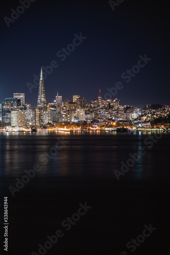 Nighttime view of San Francisco city. Calm and peaceful conditions in the bay as the city light illuminate the water. 