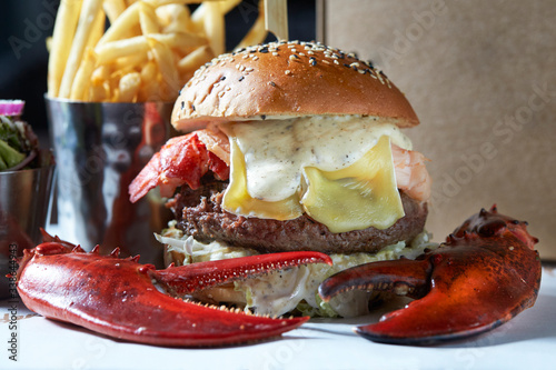 lobster roll on slate surface and burger