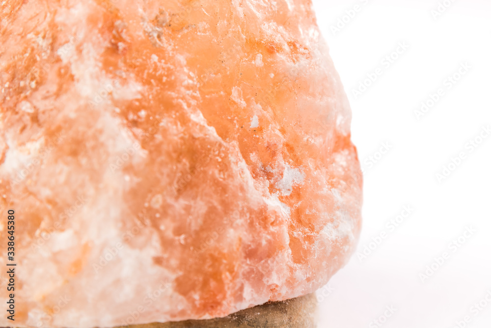Fototapeta premium Himalayan salt lamp up close macro photography - White background.
