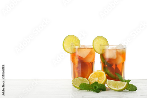 Glasses of tasty cold ice tea on white background