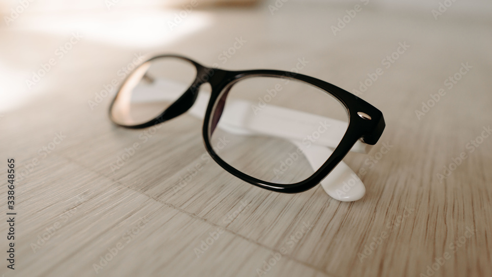 glasses on a wooden table. hipster glasses on a wooden floor. glasses for vision. white wood
