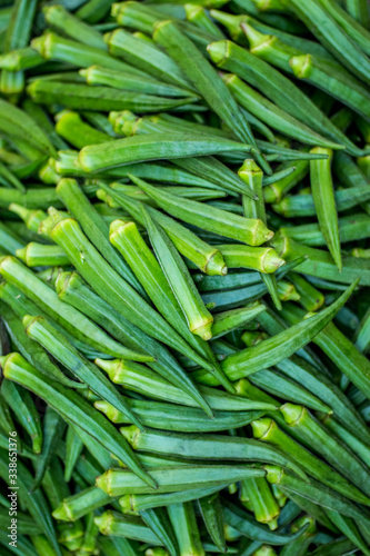 Green Ladies finger on the vegetable market - Okra, Abelmoschus esculentus, known in many countries as ladies' fingers or ochro. The geographical origin of West African, Ethiopian & Asian origins photo