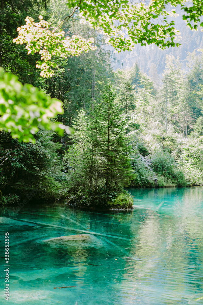 blue lake in switzerland. Mountain lake view and forest background blue lake in switzerland. Mountain lake view and forest background