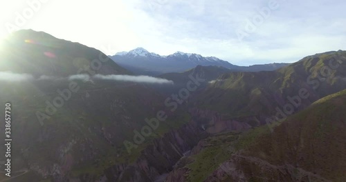 Green Mountains with Few Rays of Sun on a Cloudy Day near the Community of Sorata, La Paz / Bolivia photo