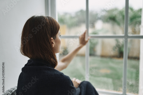 Free Download young woman looking out window - GFXLoad