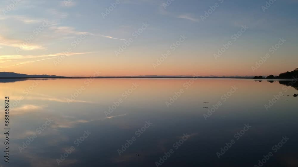 Port Nelson at the top of the South Island of New Zealand. A stunningly calm evening that turned the harbour to a mirror reflection of the sunset Port Nelson at the top of the South Island of New Zealand. A stunningly calm evening that turned the harbour to a mirror reflection of the sunset