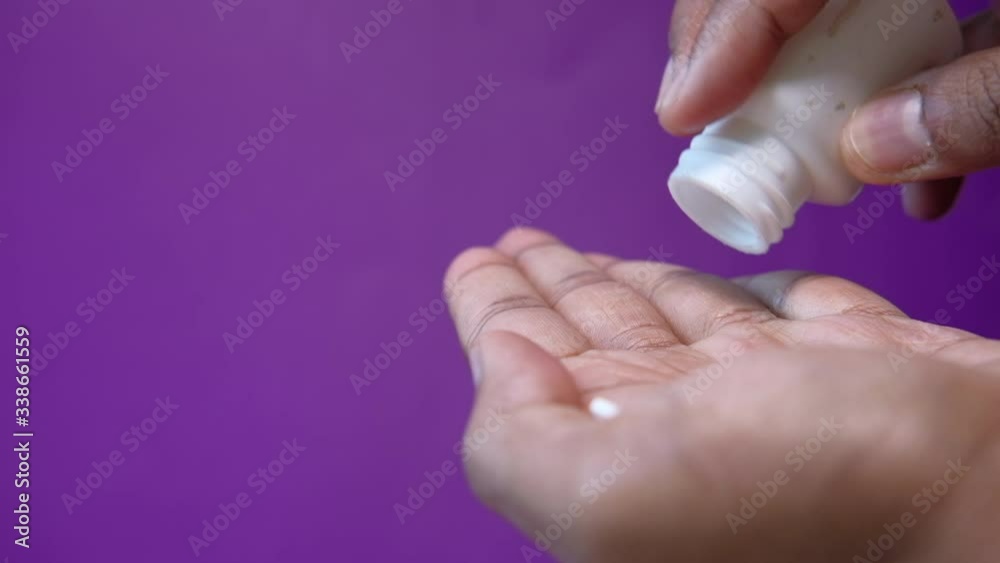 close up of white pills on palm of women hand close up of white pills on palm of women hand