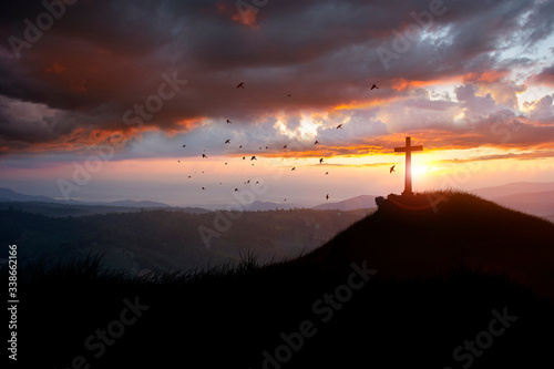 Jesus Christ cross. Easter, Concept conceptual black cross religion symbol silhouette in grass over sunset or sunrise sky