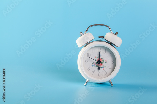 A white clock on a blue background