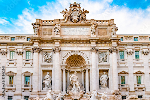 Trevi district, Rome, Italy. Palazzo Poli, a palace building, and sculptures in front on Trevi Fountain, the largest baroque water fountain in the city. Popular tourist/ sightseeing attraction.