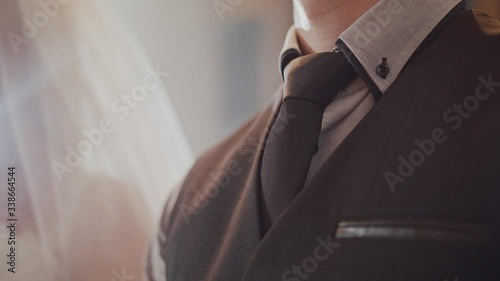 Details of groom and bride standing infront of the altar photo