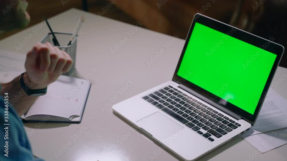 Closeup businessman talking on video call conference hands gesturing Spbas. Man looking at green screen laptop. skype discussion. concept freelance, telework, mockup. stay home during quarantine