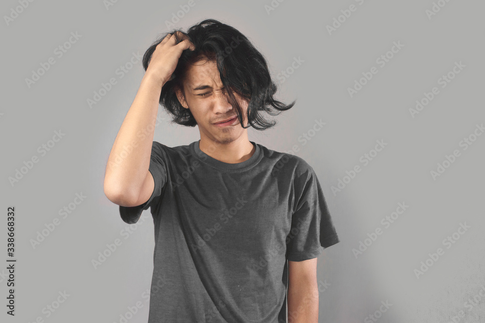 Portrait of Asain man is had doubts, sadness, speechless sad face, holding an hair. Portrait of Asain man is had doubts, sadness, speechless sad face, holding an hair.