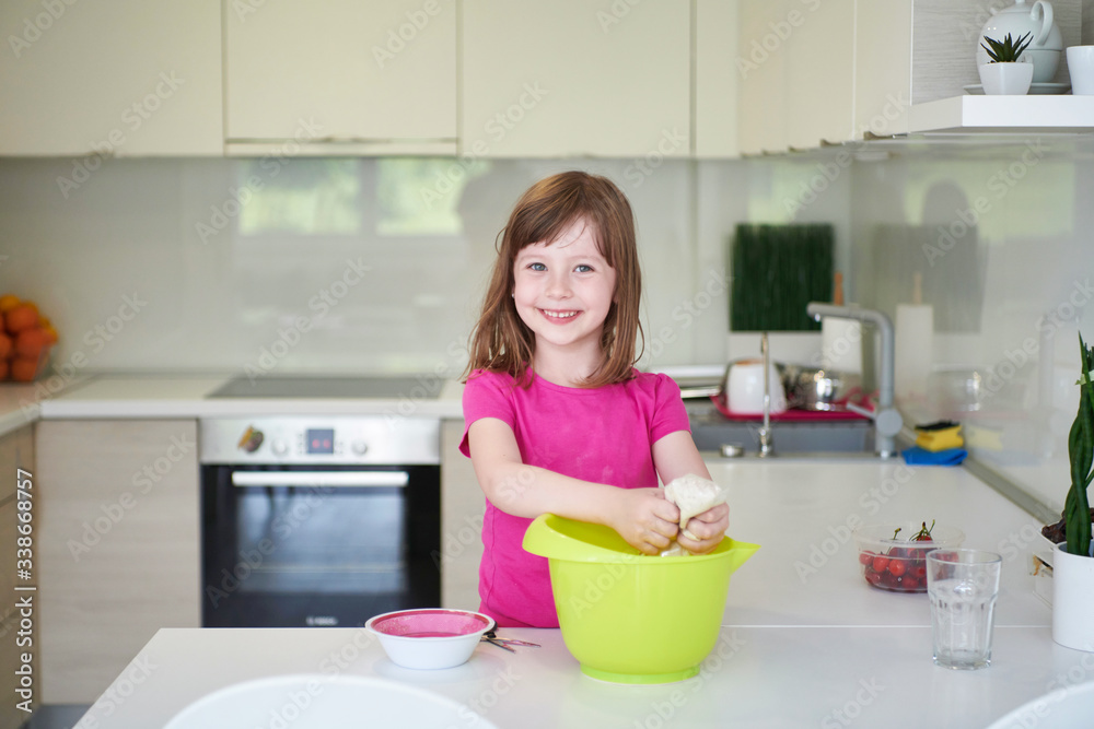 Mother and daughter playing and preparing dough in the kitchen. Mother and daughter playing and preparing dough in the kitchen.