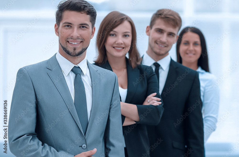 leader and the business team standing one behind the other. leader and the business team standing one behind the other.