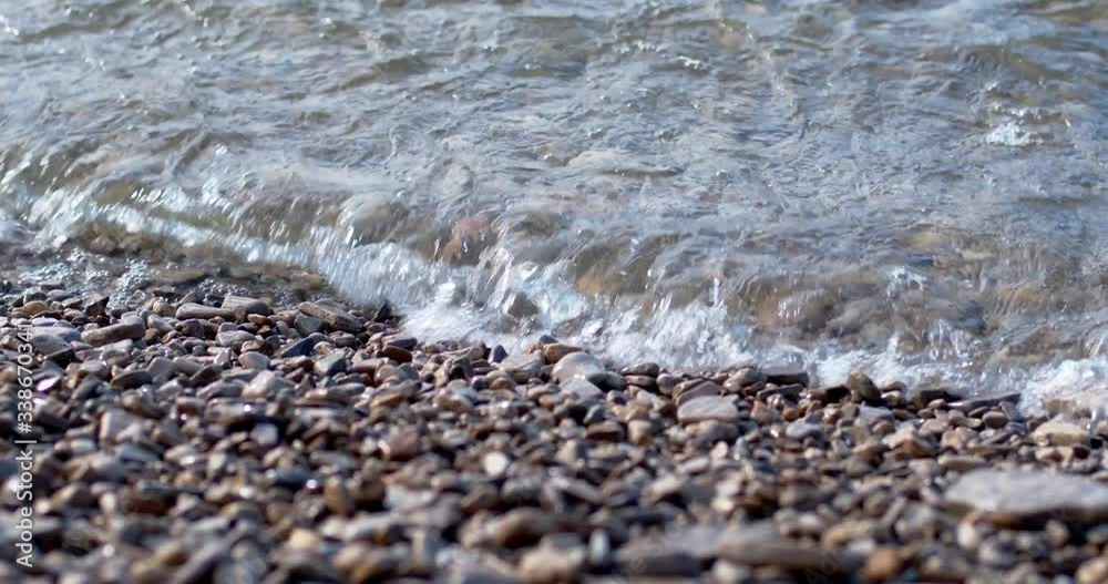 Waves lapping on rocky beach and receding Waves lapping on rocky beach and receding
