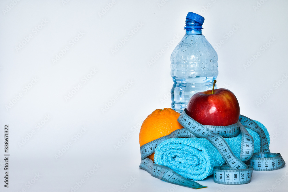 Obraz premium to do fitness in the gym. water, towel, headphones, apple on a white background top view space for text template.